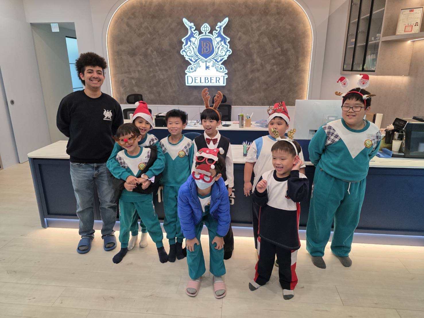 Delbert English teacher and students gathered in the reception area during a holiday activity.